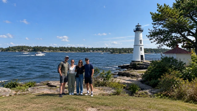 Visitors beside Rock Island Lighthouse on the St. Lawrence River during a Thousand Islands boat tour